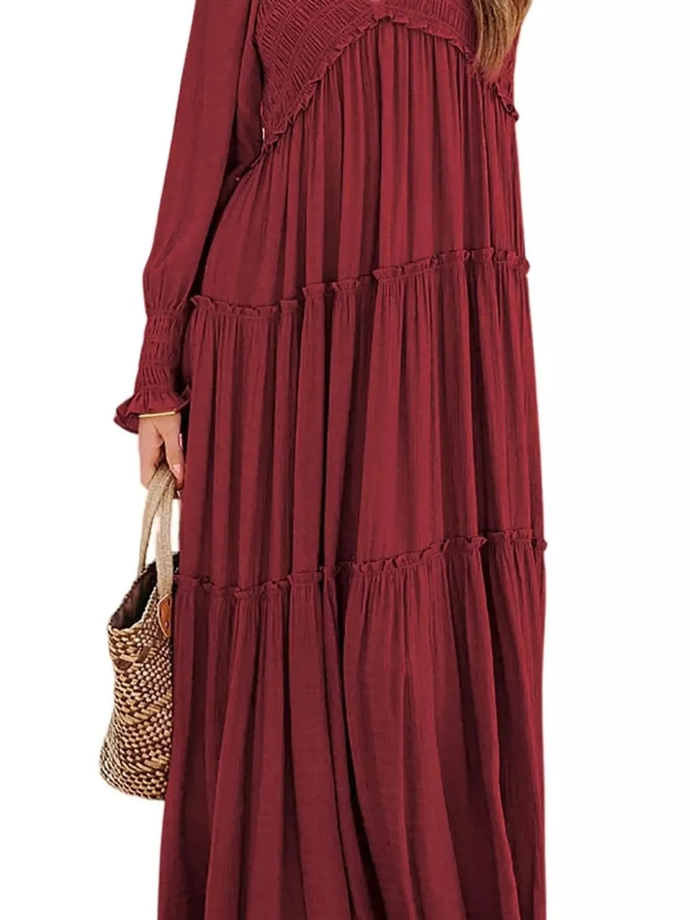 Wine red smocked v-neck tiered maxi dress with long sleeves and ruffled tiers.