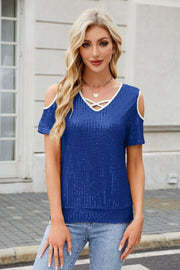 Royal blue sequin cold shoulder top with crisscross neckline trim and short sleeves.