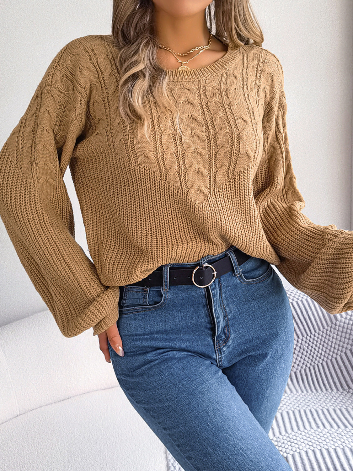 Taupe cable knit drop shoulder pullover sweater with crew neck and balloon sleeves.