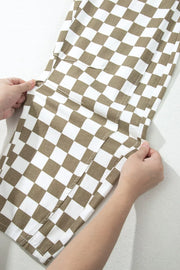 Maternity barrel pants in brown and white checkered cotton with cargo pockets.