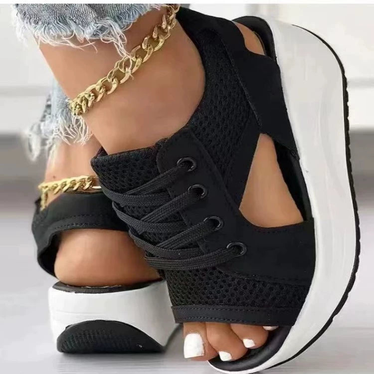 Black lace-up wedge sandals with mesh details and a white platform sole.