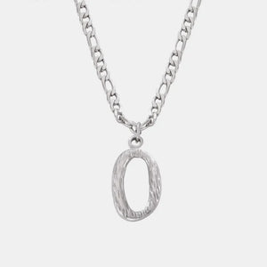 Textured initial pendant necklace in silver with a figaro chain.