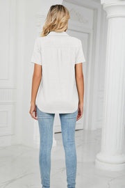 Light gray short sleeve V-neck polo with pocket detail and a curved hem.