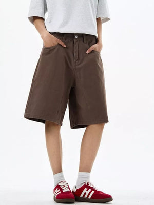 Brown chino shorts with drawstring waist and pockets, worn by a man.
