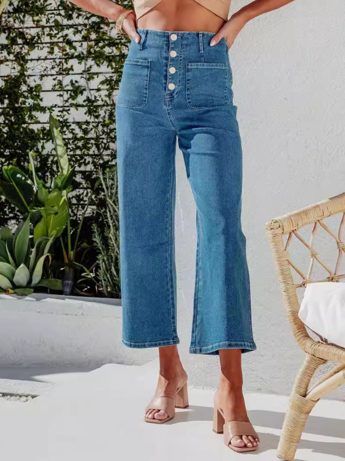 Button-front wide-leg cropped jeans in light blue denim with patch pockets.