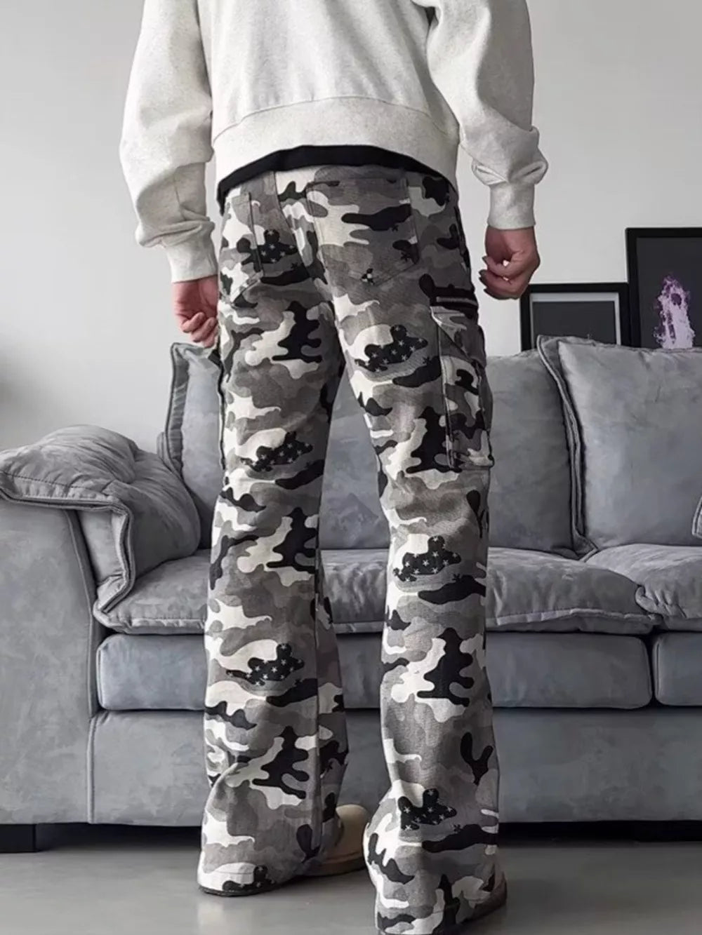 Camouflage utility wide-leg sweatpants with cargo pockets and a relaxed fit.