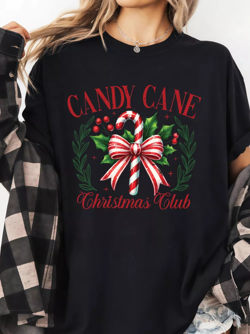 Black cotton t-shirt with festive candy cane Christmas Club graphic and wreath detail.