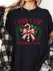 Black cotton t-shirt with festive candy cane Christmas Club graphic and wreath detail.