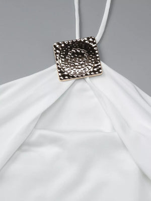 White halter neck maxi dress detail with ruched fabric and gold square embellishment.