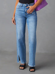 Medium wash cotton blend flare jeans with split hem detail and distressed accents.