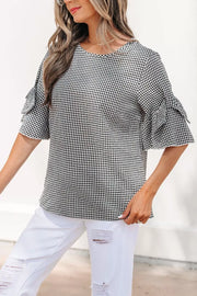 Black and white gingham polyester shirt with ruffled sleeves and a crew neck.