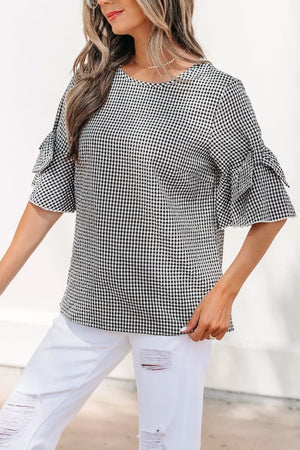 Black and white gingham polyester shirt with ruffled sleeves and a crew neck.