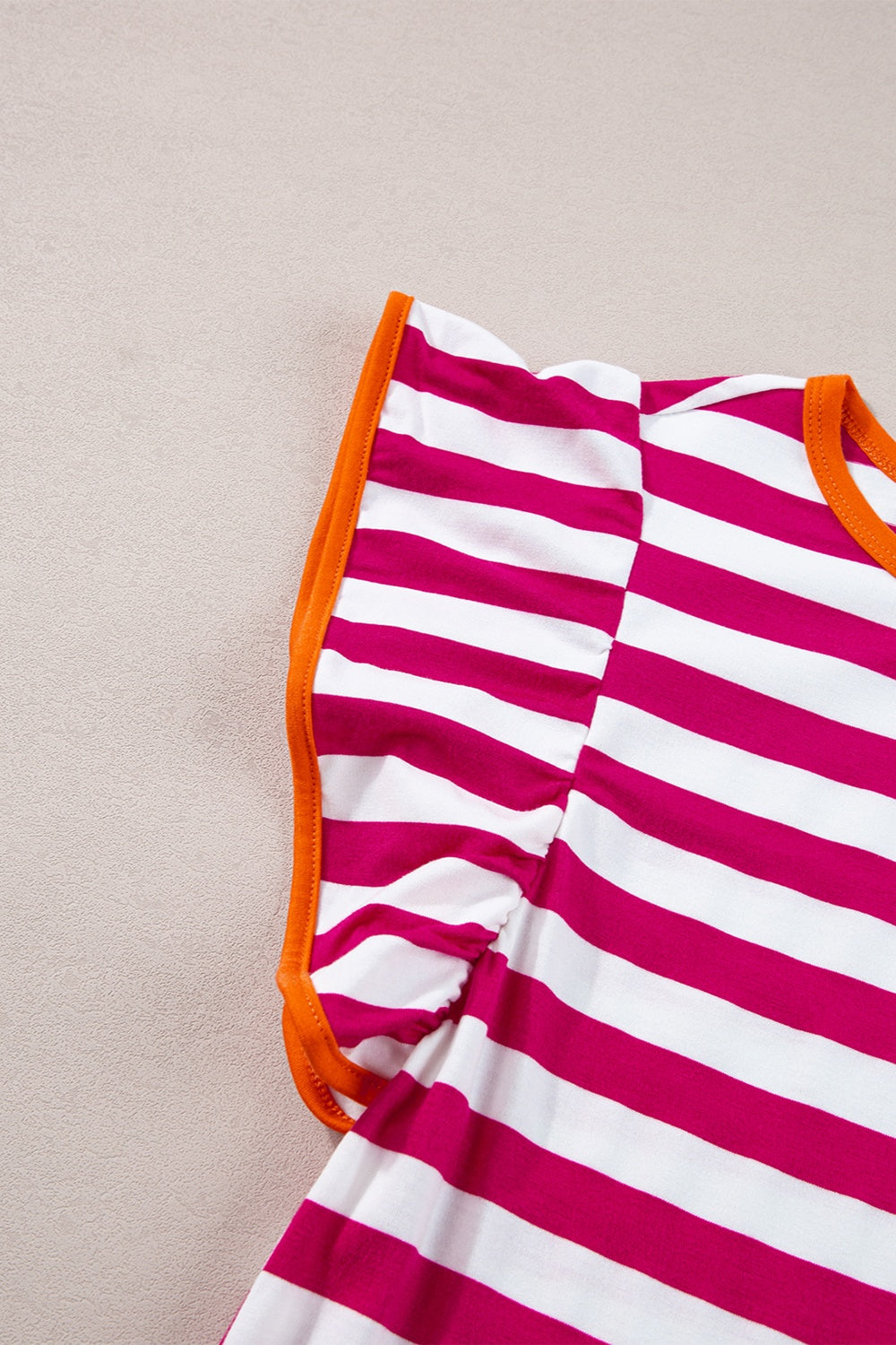 Striped tee with flutter sleeves and contrast orange trim.