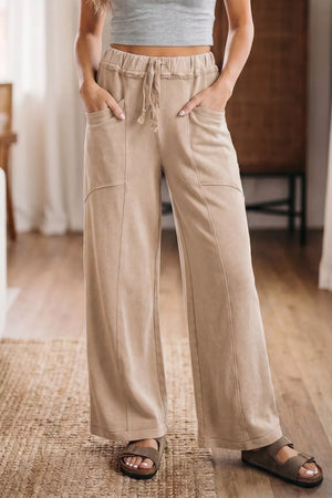 Mineral wash tan cotton wide leg maternity pants with drawstring waist and pockets.