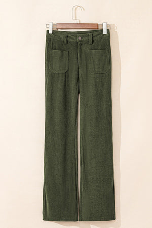 Moss corduroy flared leg trousers with patch pockets and a button closure.