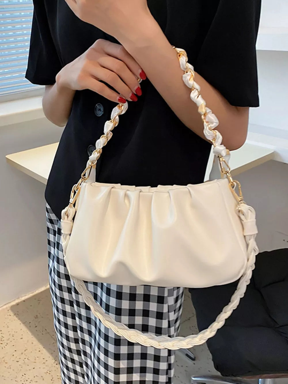 Ruched shoulder bag in beige with a braided strap and gold chain detail.