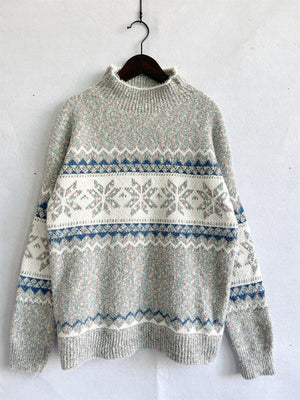 Geometric knit mockneck pullover with snowflake and chevron patterns in pastel colors.