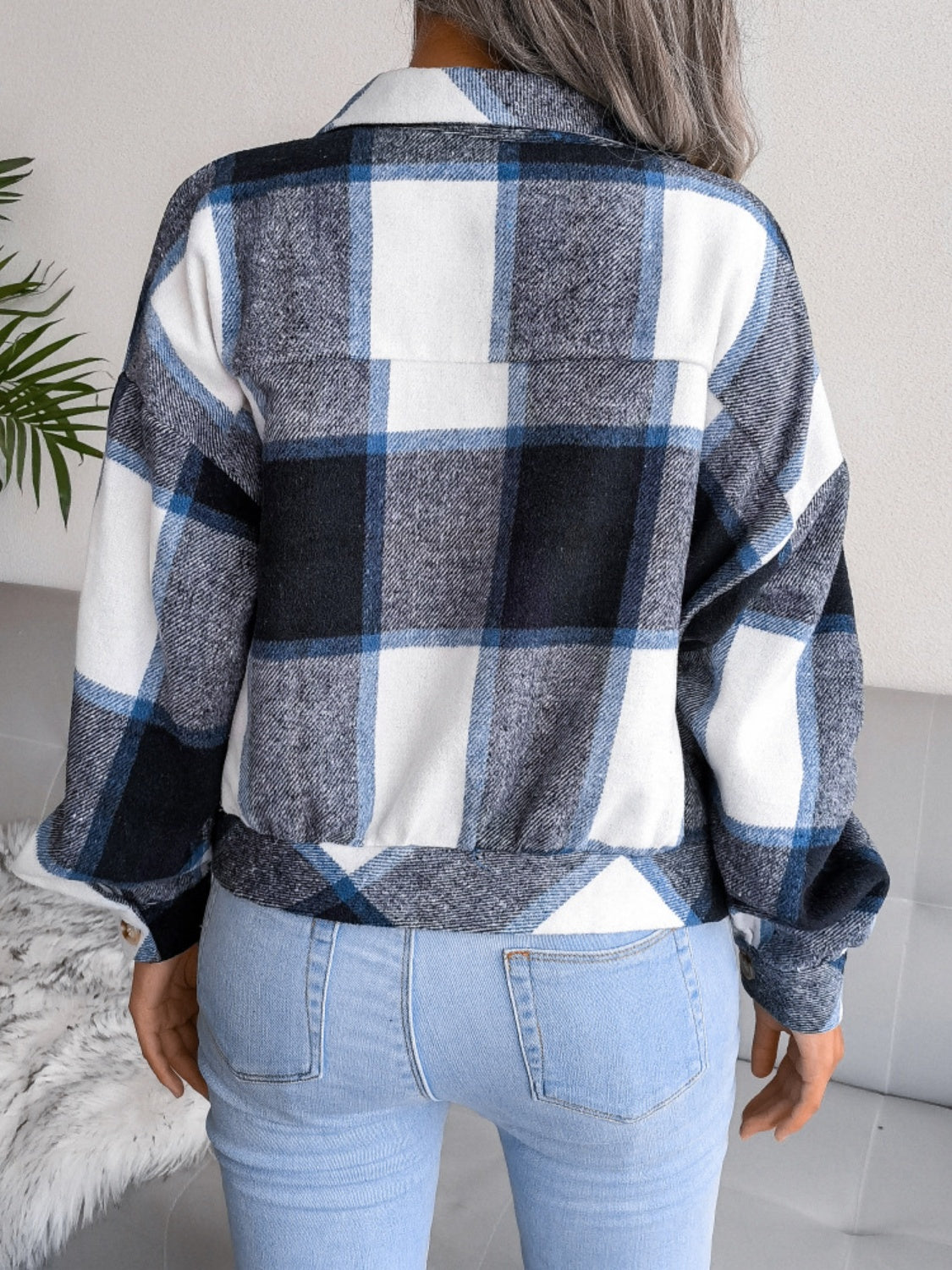 Oversized blue and white plaid shacket with buttoned front and elastic hem.