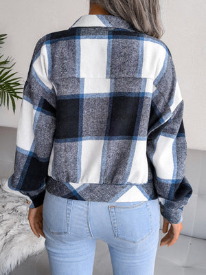 Oversized blue and white plaid shacket with buttoned front and elastic hem.