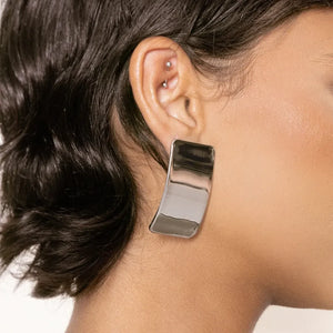 Sculpted silver-tone statement earrings with a bold, casual style.