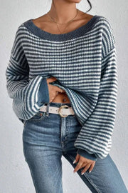 Off-shoulder blue and white striped knit pullover sweater with balloon sleeves.