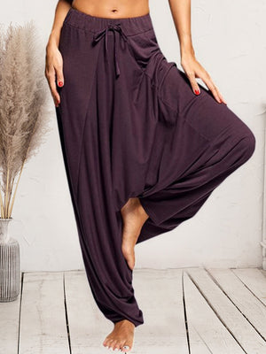 Plum drape-front drawstring harem pants with pockets and a relaxed fit.