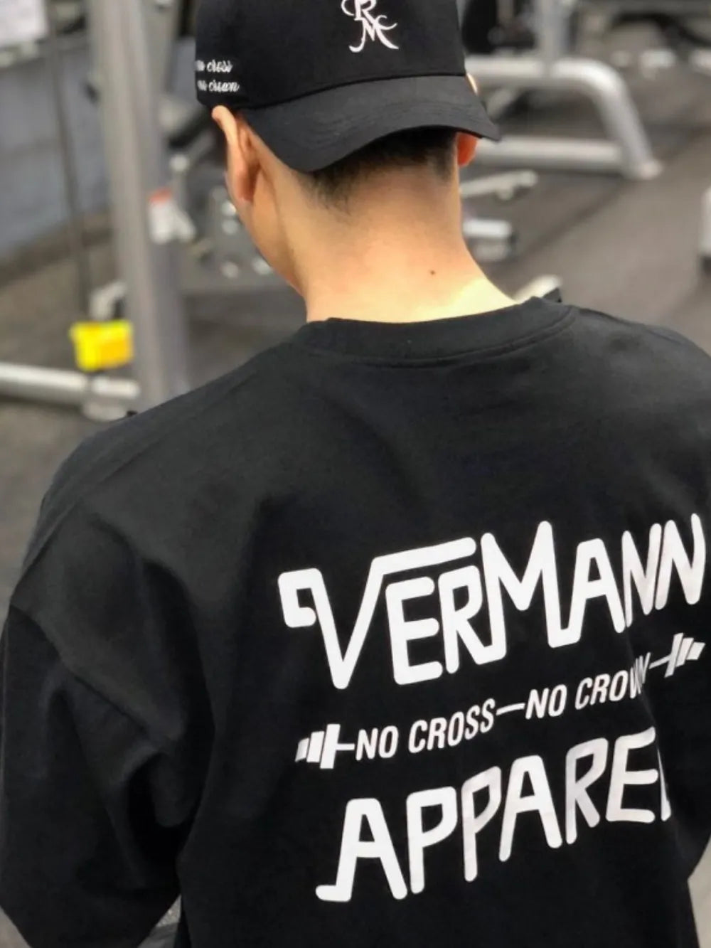 Black oversized graphic tee with Vermann Apparel logo and text print on back.