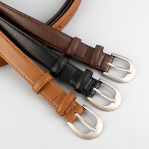Timeless cowhide leather skinny belts in caramel, black, and brown with silver buckles.