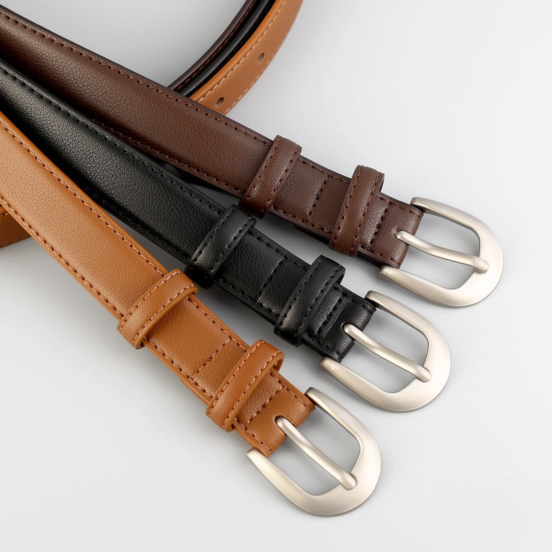 Timeless cowhide leather skinny belts in caramel, black, and brown with silver buckles.