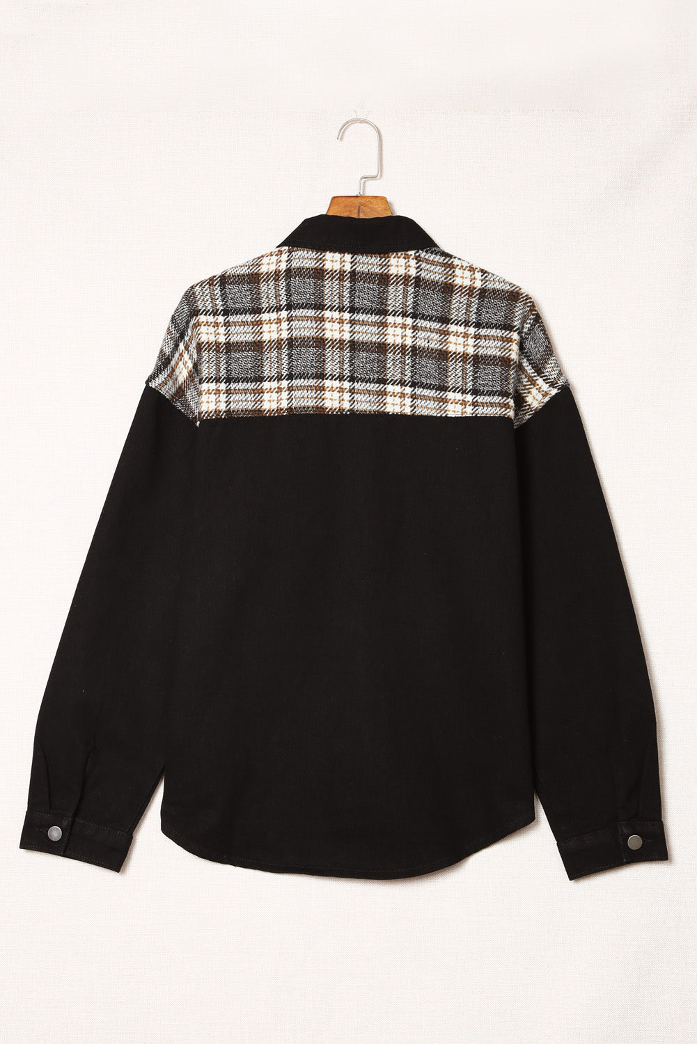 Black denim trucker jacket with plaid panel on shoulders and back.