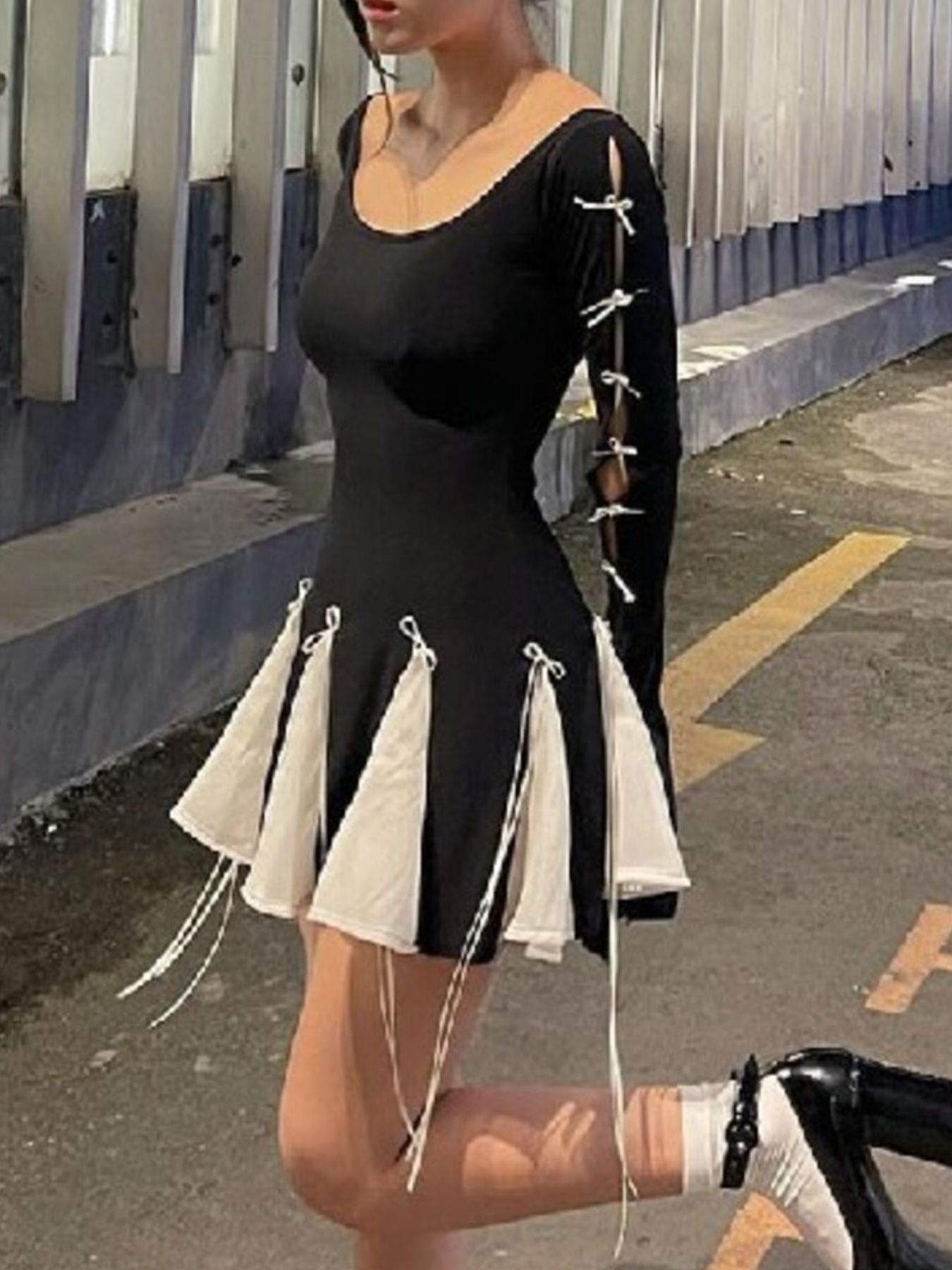 Black mini dress with bowknot details on sleeves and skirt hem.