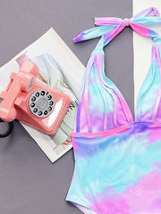 Tie-dye plunge halter swimsuit with multicolor pastel tie-dye pattern and braided straps.