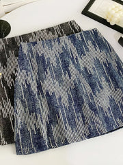 Shimmering sequin mini skirt in dark blue with vertical stripe pattern.