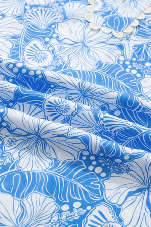 Tropical floral v-neck frill blouse in blue and white polyester with shell and starfish details.