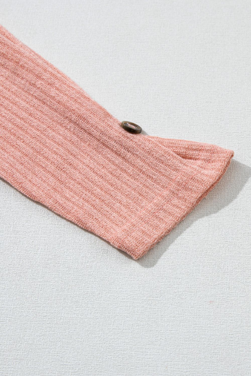 Dusty pink ribbed knit henley top sleeve detail with button