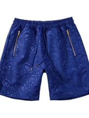 Royal blue jacquard shorts with paisley pattern and zip pockets.