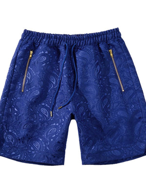 Royal blue jacquard shorts with paisley pattern and zip pockets.