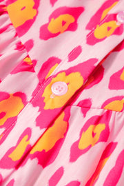 Pink leopard print blouse with button detail and balloon sleeves.