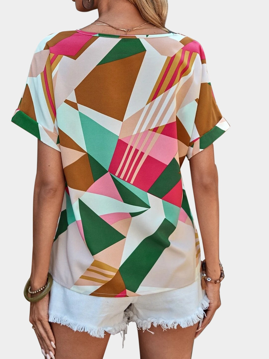 Geometric print V-neck blouse with short sleeves in multicolor.