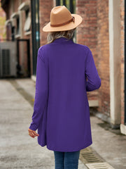Electric purple asymmetrical cardigan with a draped front and long sleeves.