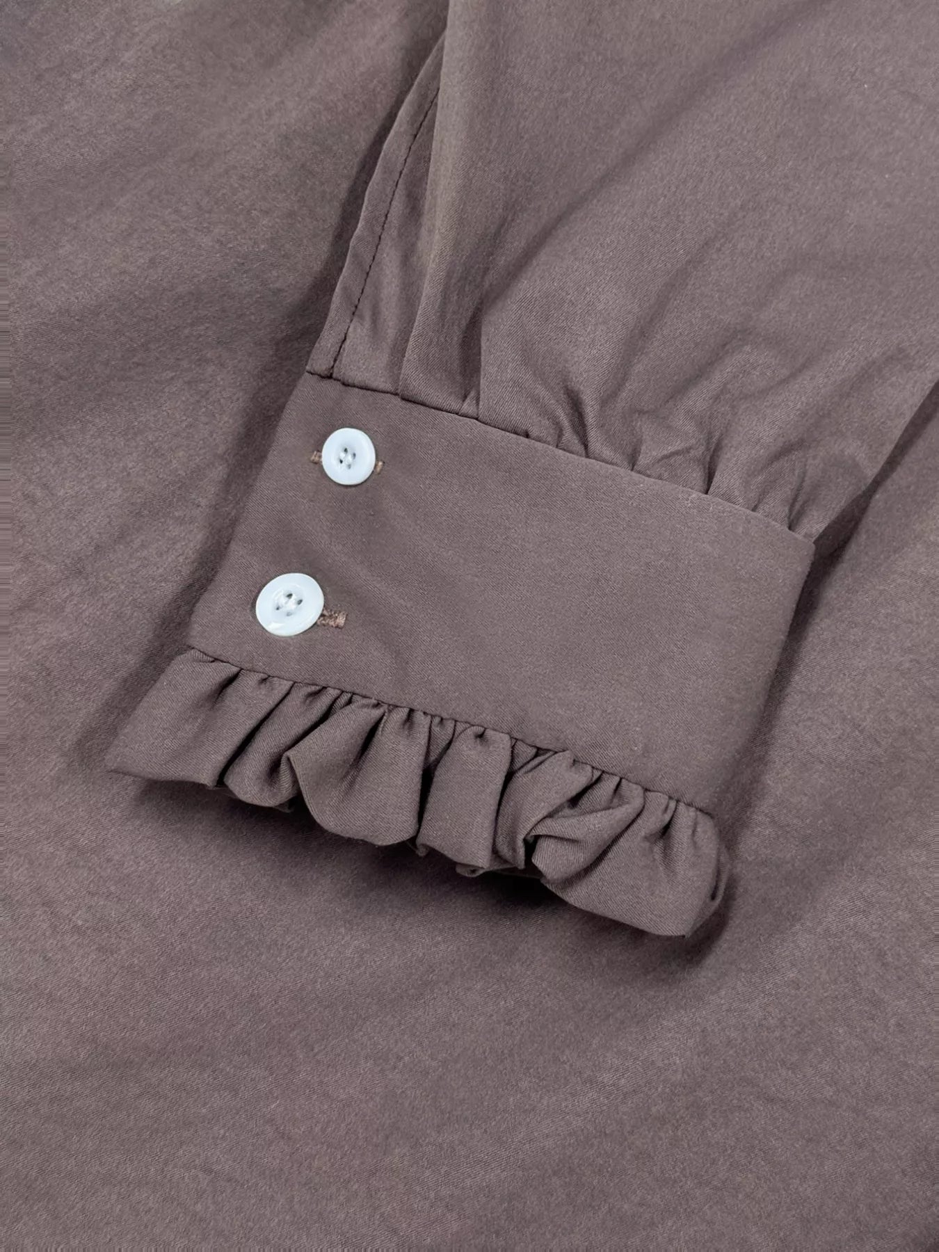 Coffee brown midi dress sleeve cuff with ruffle hem and two white buttons.