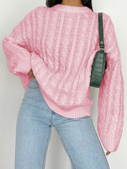 Cable knit openwork sweater in Carnation Pink acrylic with crew neck and long sleeves.