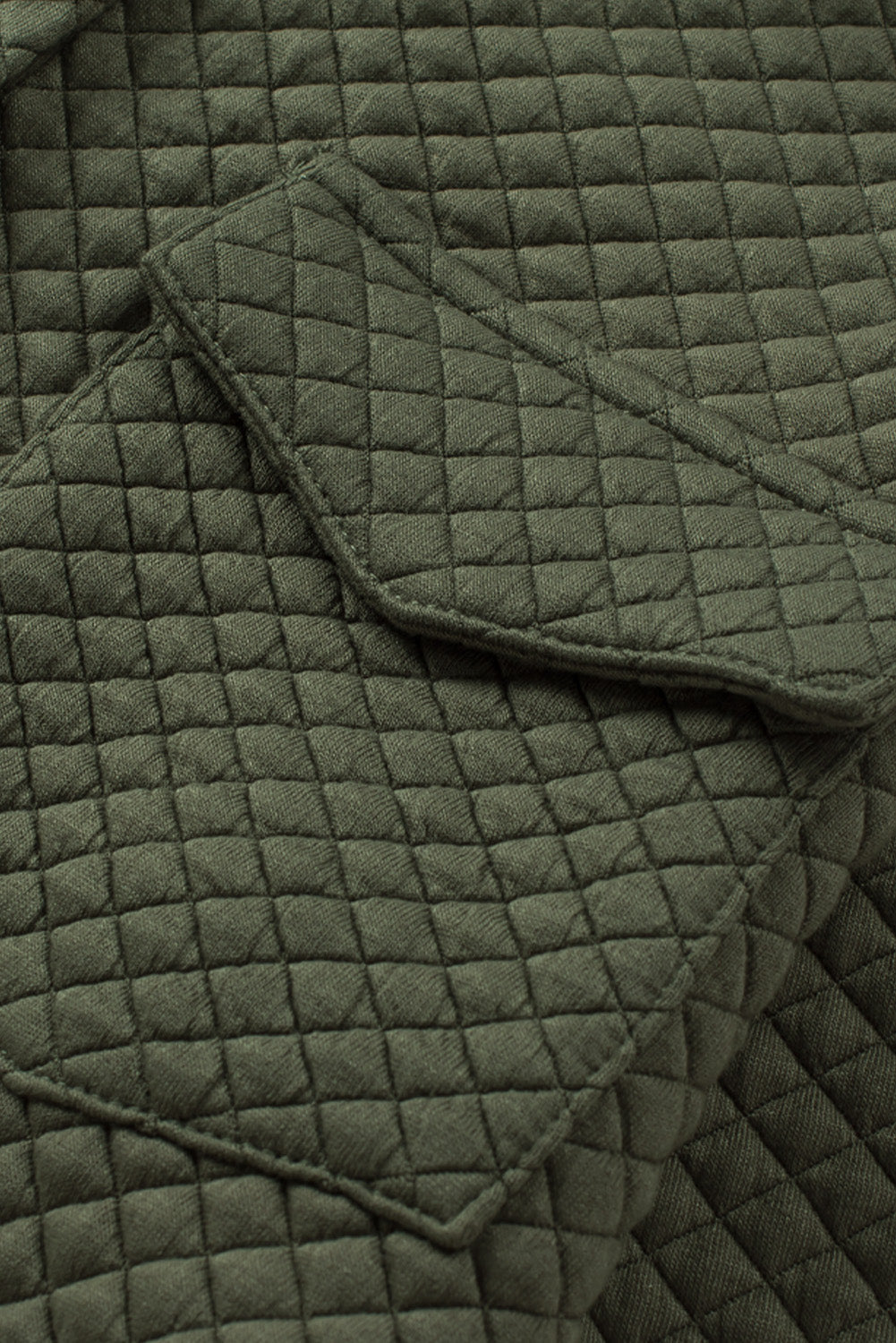 Army green quilted overshirt with diamond pattern and patch pockets.
