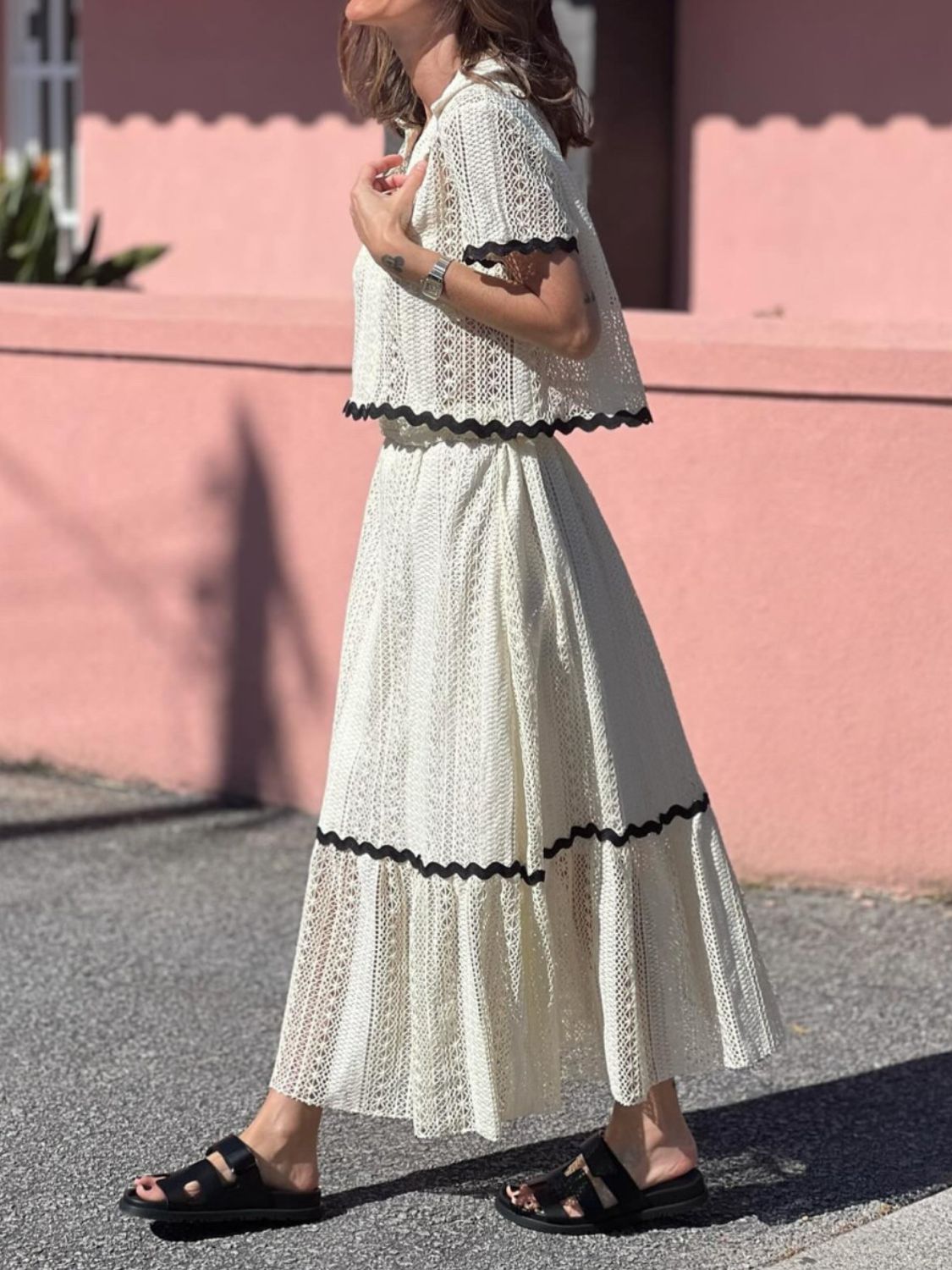 Cream crochet co-ord set with scalloped black trim detail.