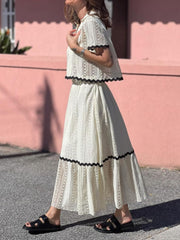 Cream crochet co-ord set with scalloped black trim detail.
