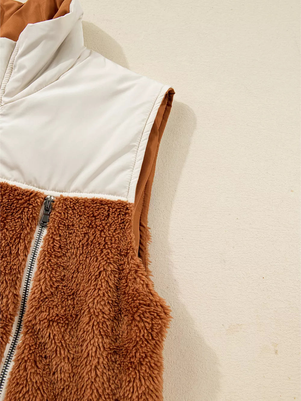 Cozy color block vest coat in brown sherpa and cream nylon with a full zipper.