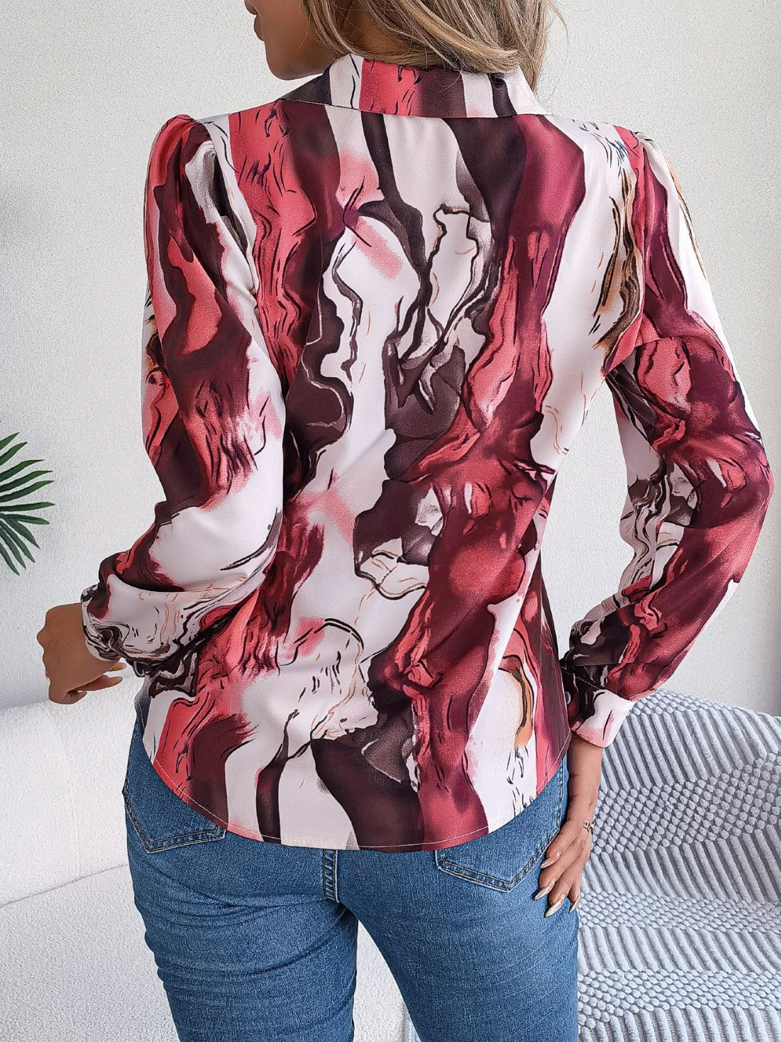 Women's abstract swirl print silk blouse with button front and long sleeves.
