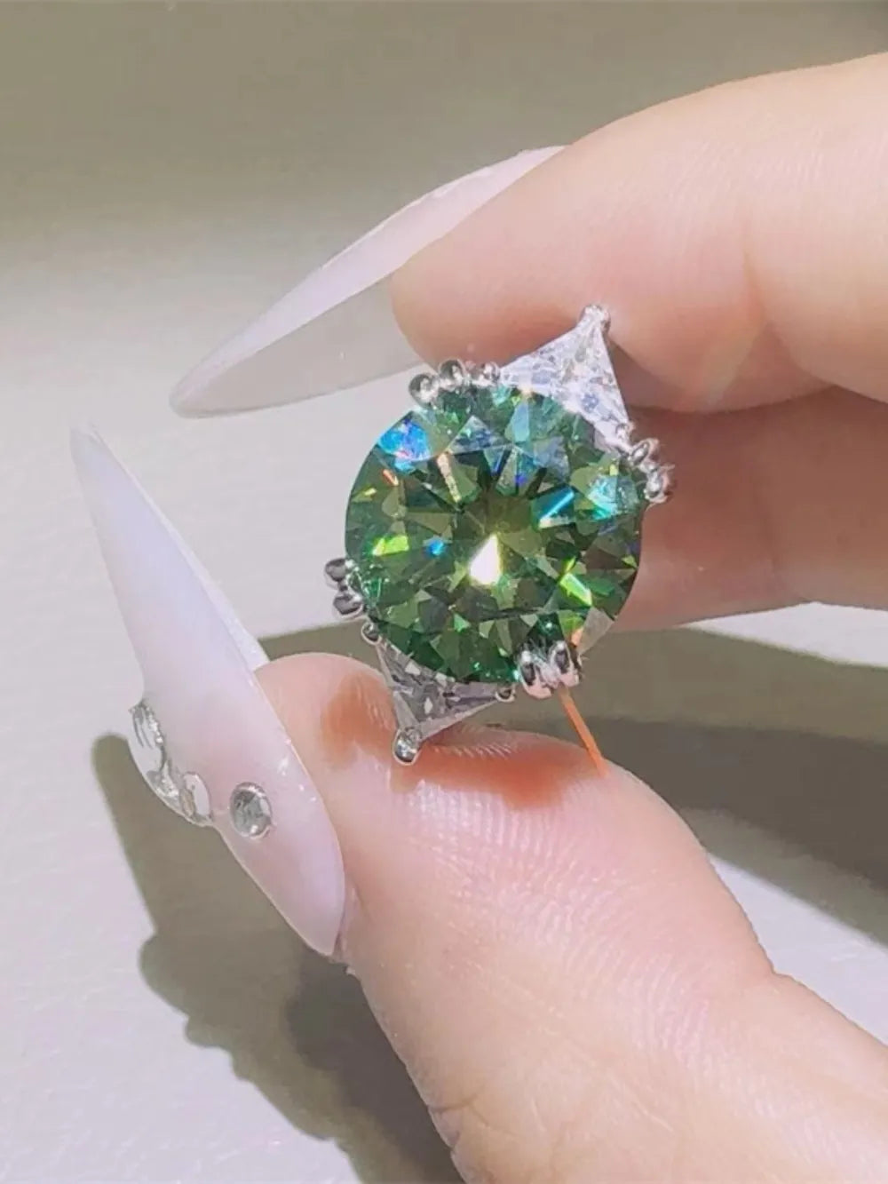 Emerald Prism Silver Ring with large green stone and accent stones.