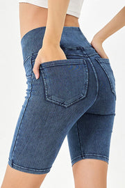 Medium wash denim bermuda shorts with crisscross waistband detail and back pockets.
