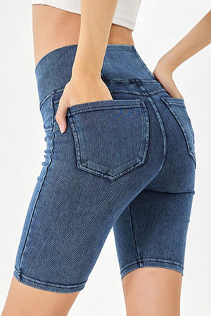 Medium wash denim bermuda shorts with crisscross waistband detail and back pockets.